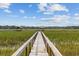 Long wooden dock leading to gazebo over calm water at 496 Myrtle Ave., Pawleys Island, SC 29585