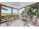 Peaceful screened porch with rocking chairs and marsh views at 496 Myrtle Ave., Pawleys Island, SC 29585