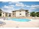 Community pool with lounge chairs and families enjoying the water at 4103 Pinehurst Circle # Bb-12, Little River, SC 29566