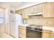 Bright kitchen features light wood cabinets, and electric range at 4103 Pinehurst Circle # Bb-12, Little River, SC 29566
