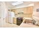Clean kitchen with light wood cabinets, and stainless steel sink at 4103 Pinehurst Circle # Bb-12, Little River, SC 29566
