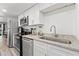 Modern kitchen features stainless steel appliances and granite countertops at 7509 N Ocean Blvd. # 103, Myrtle Beach, SC 29572