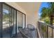 Balcony with sliding door access and view of street and palm trees at 7509 N Ocean Blvd. # 103, Myrtle Beach, SC 29572