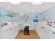 Well-lit laundry room with several modern washing machines and dryers at 7509 N Ocean Blvd. # 103, Myrtle Beach, SC 29572