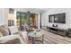 Bright living room with balcony access and stylish furniture at 7509 N Ocean Blvd. # 103, Myrtle Beach, SC 29572