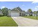 Two-story house with a two-car garage, landscaping, and driveway at 1620 Palmetto Palm Dr., Myrtle Beach, SC 29579