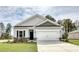 Charming single-story home with gray siding, white garage door, and landscaped yard at 4723 Huckleberry Ln., Conway, SC 29526