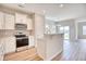 Modern kitchen with white cabinets, stainless steel appliances, and an island with breakfast bar at 4723 Huckleberry Ln., Conway, SC 29526