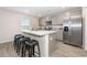 Kitchen island with seating, stainless steel appliances, and gray cabinets at 167 Country Grove Way, Galivants Ferry, SC 29544