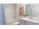 Clean bathroom with a white tub, gray vanity, and a blue patterned shower curtain at 201 Hadley Springs Ave, Longs, SC 29568