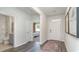 Bright and airy entryway with hardwood floors, a view into a bedroom and bathroom, and framed art at 201 Hadley Springs Ave, Longs, SC 29568