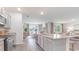 Open concept kitchen with an island, stainless steel appliances, and a view into the dining area at 201 Hadley Springs Ave, Longs, SC 29568