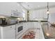 Spacious kitchen with granite countertops and white cabinetry at 213 South Myrtle Dr., Surfside Beach, SC 29575