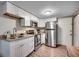 Efficient galley kitchen features white cabinets, granite countertops, and stainless steel appliances at 6850 Blue Heron Blvd. # 406, Myrtle Beach, SC 29588
