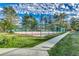 Well-maintained tennis court with a surrounding fence and walkway at 6850 Blue Heron Blvd. # 406, Myrtle Beach, SC 29588