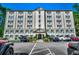 Building exterior with ample parking and landscaping at 6850 Blue Heron Blvd. # 406, Myrtle Beach, SC 29588