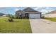 Brick ranch home with a large driveway and landscaped yard at 197 Golden Bear Circle, Longs, SC 29568