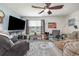 Bright living room featuring comfortable seating, large TV, and backyard view at 197 Golden Bear Circle, Longs, SC 29568