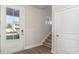 Bright entryway with stairs, wood-look floors, and coat closet at 1020 Barrington Way, Conway, SC 29526