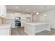 Modern kitchen with white cabinets, stainless steel appliances and large island at 1020 Barrington Way, Conway, SC 29526