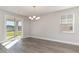 Bright dining room with hardwood floors, chandelier, and sliding glass door to patio at 1020 Barrington Way, Conway, SC 29526