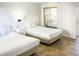Bedroom with two twin beds and mirrored closet at 202 74Th Ave. N # 2447-2448, Myrtle Beach, SC 29572