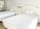 Bedroom with two twin beds and white bedding at 202 74Th Ave. N # 2447-2448, Myrtle Beach, SC 29572