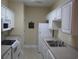 White kitchen with appliances and a double sink at 5011 Harvest Dr. # 203, Myrtle Beach, SC 29579