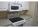 White appliances and cabinets are featured in this well-lit kitchen at 5011 Harvest Dr. # 203, Myrtle Beach, SC 29579