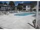 Kidney shaped pool with surrounding lounge chairs at 5011 Harvest Dr. # 203, Myrtle Beach, SC 29579