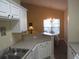 Kitchen with white cabinets and view into dining area at 5011 Harvest Dr. # 203, Myrtle Beach, SC 29579