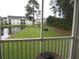 View from balcony shows pond, trees, and buildings at 5011 Harvest Dr. # 203, Myrtle Beach, SC 29579