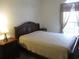 Bright bedroom with a double bed, nightstand, and large window at 5011 Harvest Dr. # 203, Myrtle Beach, SC 29579