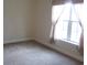 Bright bedroom with a large window and neutral colored carpet at 5011 Harvest Dr. # 203, Myrtle Beach, SC 29579