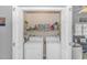 Well-lit laundry room, washer, dryer, and shelving for storage at 6001-1889 S Kings Hwy., Myrtle Beach, SC 29575