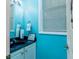 Small bathroom with blue walls, white vanity, and black countertop at 5356 Hamps Rd., Nichols, SC 29581