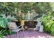 Private brick patio with metal chairs and lush greenery at 5356 Hamps Rd., Nichols, SC 29581