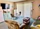 Living room with seating, glass-top table, and access to patio at 1025 Plantation Dr. W # 3421, Little River, SC 29566