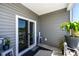 Relaxing screened porch with sliding glass door and potted plants at 238 Marauder Dr., Longs, SC 29568