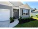 Gray siding house with a gray front door and landscaped yard at 238 Marauder Dr., Longs, SC 29568