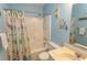 Clean bathroom with shower/tub combo and beachy decor at 4305 S Ocean Blvd. # 106, North Myrtle Beach, SC 29582