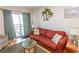 Living room with comfortable sofa and access to balcony at 4305 S Ocean Blvd. # 106, North Myrtle Beach, SC 29582
