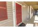 Exterior view of building entrance with red door at 4305 S Ocean Blvd. # 106, North Myrtle Beach, SC 29582