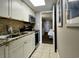 Galley kitchen with granite countertops and white cabinets at 6900 Ocean Blvd. # 936, Myrtle Beach, SC 29572
