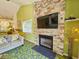 Cozy living room with stone fireplace and large TV at 226 Westleton Dr. # 19-D, Myrtle Beach, SC 29572