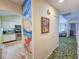 Hallway with beach-themed mural and view of kitchen at 226 Westleton Dr. # 19-D, Myrtle Beach, SC 29572