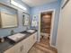 Modern bathroom with double sinks, a walk-in shower, and wood-look tile floors at 226 Westleton Dr. # 19-D, Myrtle Beach, SC 29572