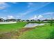 Backyard with pond view, green grass, and white fence at 629 Swinford Dr., Myrtle Beach, SC 29588