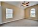 Bright bedroom with carpet flooring, ceiling fan and two windows at 629 Swinford Dr., Myrtle Beach, SC 29588