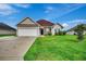 House exterior with attached garage, lawn, and driveway at 629 Swinford Dr., Myrtle Beach, SC 29588